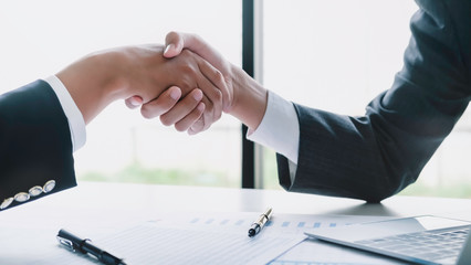 Asian Businessman handshake and business people. Business executives to congratulate the joint business agreement.Vintage tone Retro filter effect,soft focus,low light.