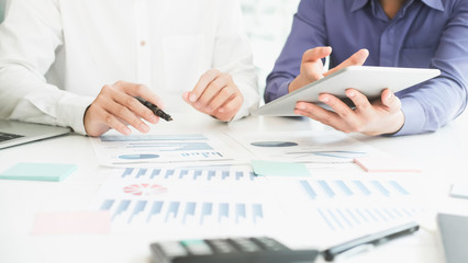 Business man supervising and secretary to execute business plan and consultant analyzing company annual financial report balance sheet statement working with documents graphs. Audit and consultant