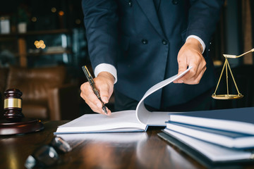 Partner lawyers or attorneys discussing a contract agreement. Successful businessmen hand putting...