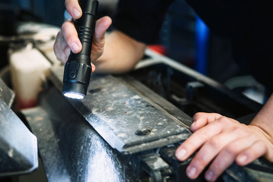 Mechanic checking a car - Powered by Adobe