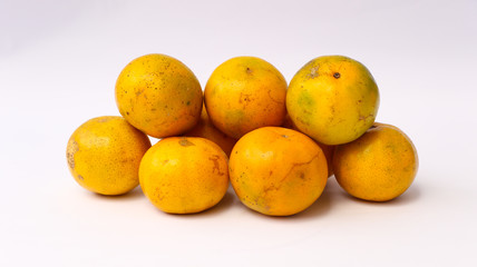 Close up view of orange fruits (buah jeruk), rich vitamin C, isolated on white background