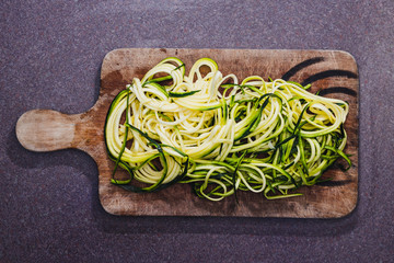 wholesome food ingredients, spiralized zucchini on cutting board