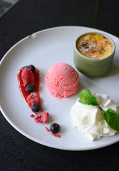 Creme brulee,French vanilla cream dessert Served with berry sauce,Strawberry Ice Cream, Whipped cream and caramelised sugar on top