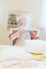 Obraz na płótnie Canvas Little girl baking in the kitchen at home