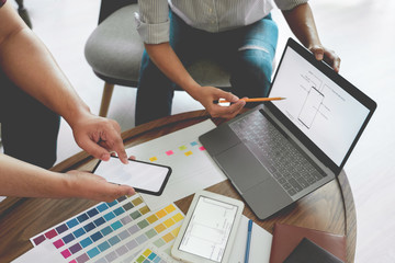 Creative team analyzing prototype products for product design in Coworking Space, teamwork...