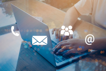 Contact us or Customer support hotline people connect. Businessman using a laptop with the (email, call phone, mail) icons.
