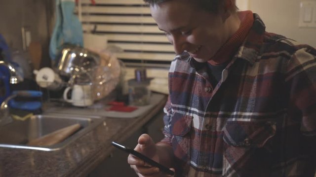 Woman Enjoy Using Her Phone in The Kitchen - Close Up Shot