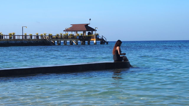 Girl Sitting On A Beach Of Samal Island