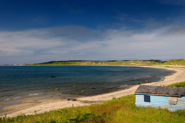 Abandoned fishing shacks on the beach at Broom Point Gros Morne National Park Newfoundland