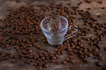 coffee beans and empty cup on a table