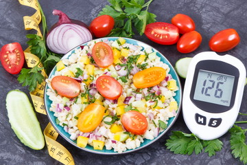Glucose meter for analyzing sugar level and salad with bulgur groats and vegetables. Diabetes,...