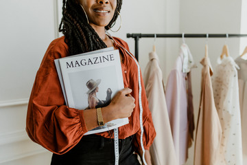 Fashion designer holding a magazine