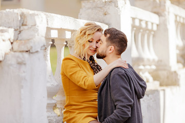 a couple of hipsters and beauties in love walk on a date in the spring city, a young stylish couple