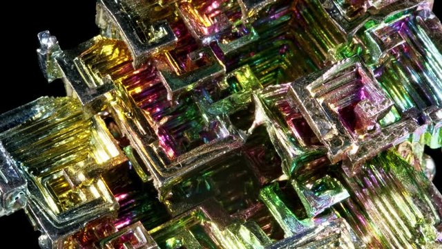 Macro of the stone bismuth mineral on a black background close up