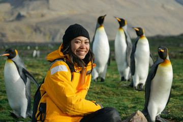 Woman with Penguins in Background - obrazy, fototapety, plakaty