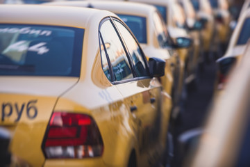 View of yellow taxi cab parking lot with yellow cars standing, set of taxicabs in the streets, taxis