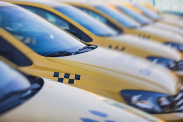 View of yellow taxi cab parking lot with yellow cars standing, set of taxicabs in the streets, taxis