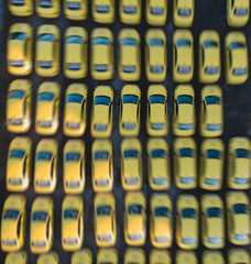 Aerial drone view of yellow taxi cab parking lot with yellow cars standing, set of taxicabs in the...