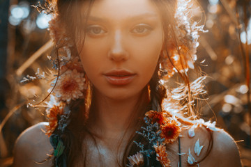close up portrait of young and tender woman on a feild at sunset