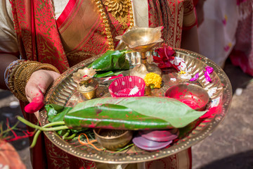 Woman holding a ceremonial plate used for worshipping God, during Sindur Khela at a puja pandal on...