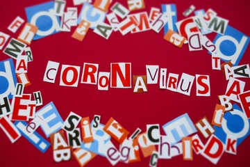 Fototapeta premium Coronavirus infection epidemic concept.Coronavirus News. Coronavirus statistics.word Coronavirus from newspaper letters on a red background. Medicine and Health.Informational News Concept