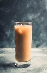 Iced coffee with cream on the rustic background. Selective focus. Shallow depth of field.