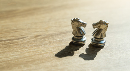 Two golden horse chess together with shadow in concept, business, negotiation, success and...