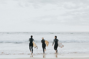 Surfers going into the water
