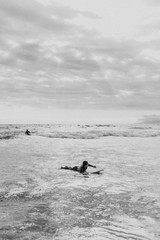Surfer floating on the surfboard
