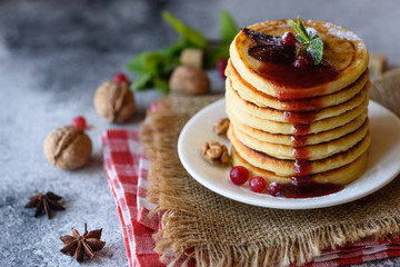 Delicious fresh beautiful pancakes with citrus honey and jam