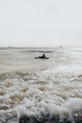 Surfer floating on the surfboard