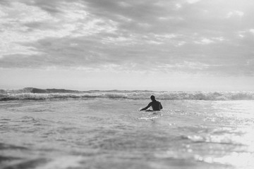 Surfer floating on the surfboard