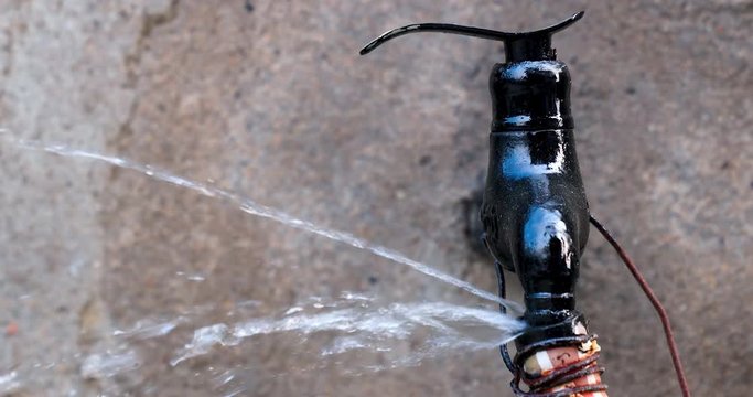 Leakage from root concept. Water leaking from tap connected to lose end of a hose.