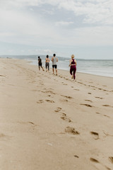 Fit people jogging on the beach
