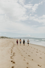 Fit people jogging on the beach