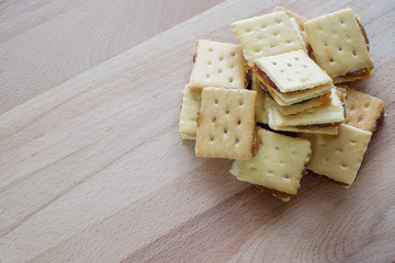 biscuits with pineapple jam on wood background