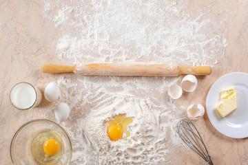 Kitchen table with ingredients for cooking baking. Copy space. Cooking concept. Eggs, flour on background. Dough ingredients.