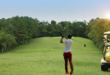 Golfer playing golf in beautiful golf course in the evening golf course with sunshine in thailand