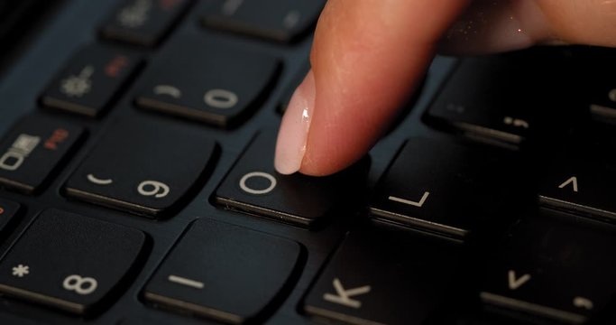 Pushing O button on the black keyboard. English letters. Used Macro lens and slow-mo.