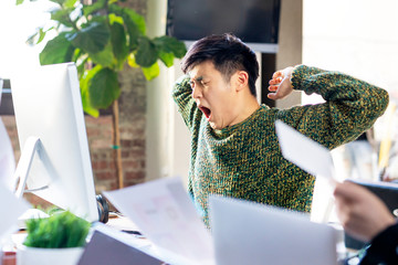 Sleepy office worker at his workstation