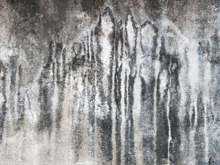 The old cement wall has water stains.