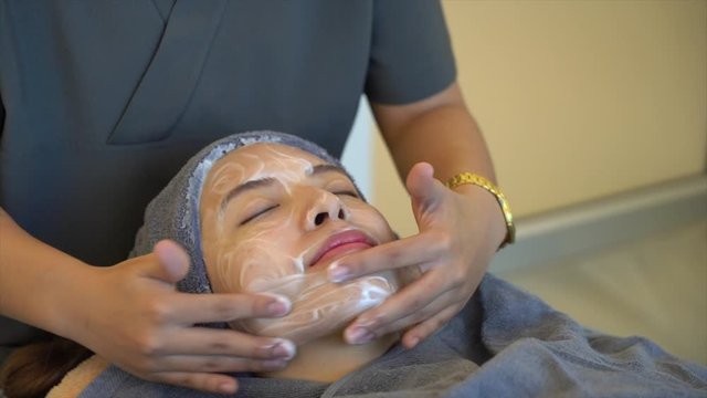 Woman clean skin of the face and receiving massage. Anti aging treatment and plastic surgery concept