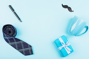 Happy Fathers Day background with wallet, gift box, coffee cup, pen, leather belt, funny moustache on table top view. Flat lay style, overhead, mockup, template, copy space