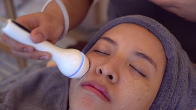 Female receiving Anti-Aging cosmetics using ultrasound cavitation machine.