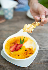 Creme brulee,French vanilla cream dessert with strawberry and caramelised sugar on top