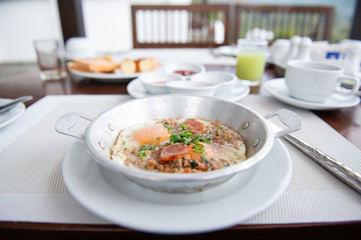 pan-fried egg with pork and toppings on table, thai style breakfast