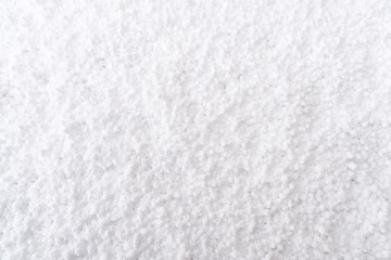 Fototapeta na wymiar Background of fresh white snow. Winter snowflakes texture. Snow white texture winter background. Icy surface pattern. Shiny snow with bokeh