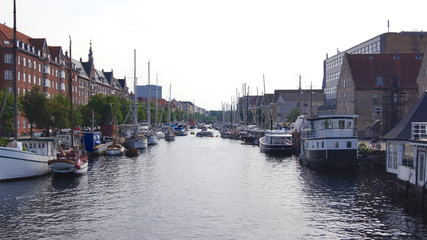 Fototapeta na wymiar COPENHAGEN, DENMARK - JUL 05th, 2015: Unidentified ships on Christianshavn - canal make a sightseeing by boat through the the city