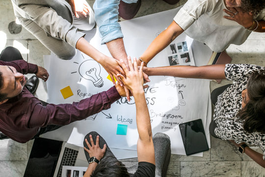 Diverse startup business team stacking hands