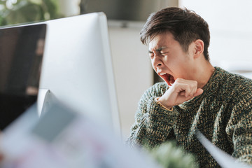 Sleepy office worker at his workstation